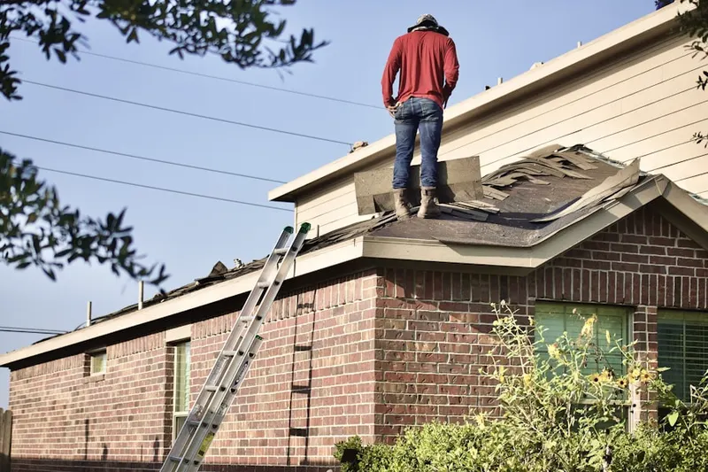 Professional roofer working on a residential roof in Rollingreen